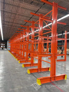 Installation of double-sided structural cantilever rack shown with 3 levels for long lengths storage application