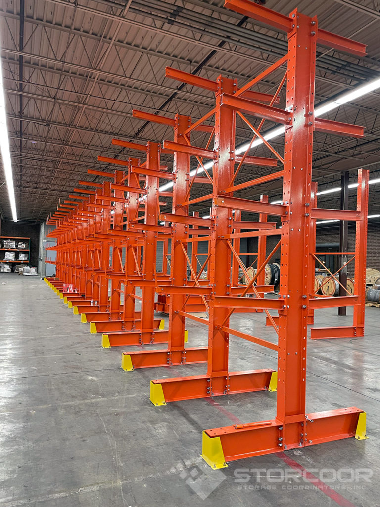 Installation of double-sided structural cantilever rack shown with 3 levels for long lengths storage application